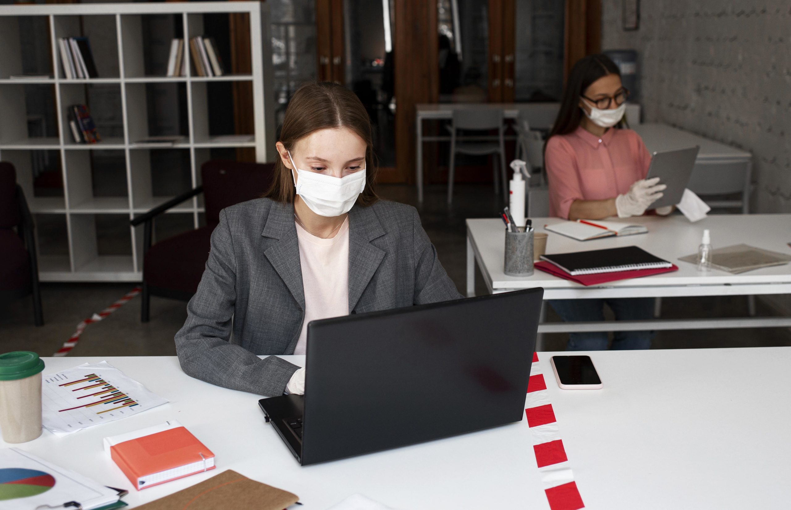 Woman in mask with laptop