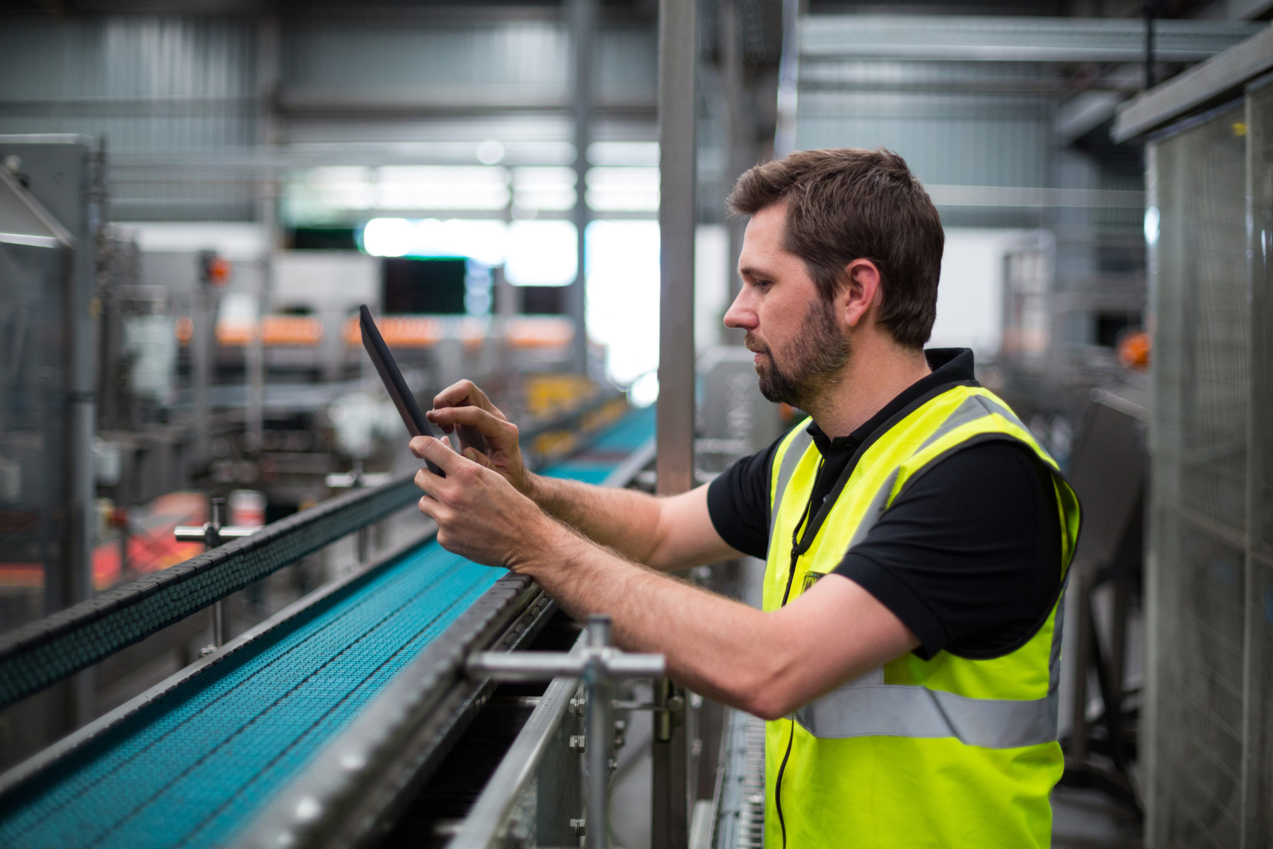 Factory worker using a digital tablet in factory