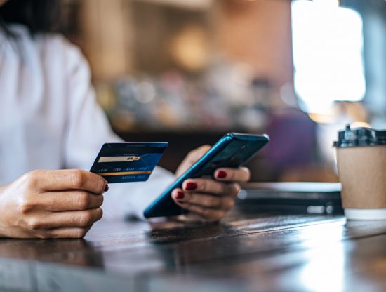 pay goods by credit card through smartphone coffee shop.jpg