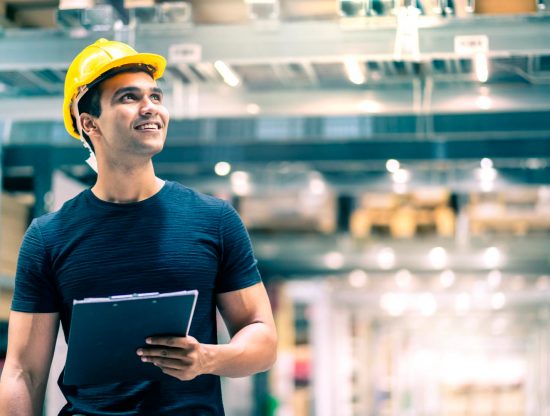 smart indian engineer man wearing safety helmet doing stock tick check cardboard stock product management factory warehouse background 1.jpg